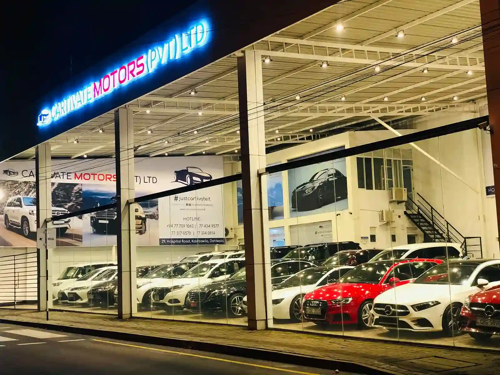 Buy cars in Sri Lanka Interior of the Cartivate Motors showroom, a premier destination for luxury car sales in Sri Lanka. The modern, spacious showroom features a curated collection of high-end vehicles, including SUVs and sedans, elegantly displayed under bright professional lighting. A trusted hub for premium car sales in Sri Lanka located in Colombo.